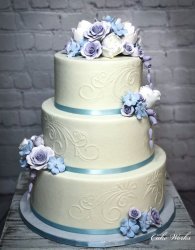 Stenciled buttercream with pastel sugar flowers