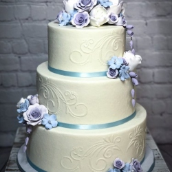 Stenciled buttercream with pastel sugar flowers